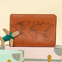 Brown leather wallet with world map design on a light beige background