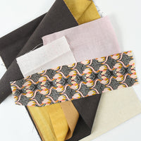 Collection of fabric swatches in various colors and patterns on a white background