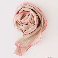 Beige scarf with pink trim on a white background