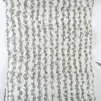 Floral patterned fabric with a pencil on a white background