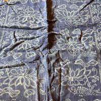 Blue fabric with white patterns on a wooden surface