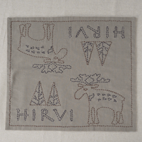 Embroidered patch with deer design and 'HIRVI' text on a fabric background
