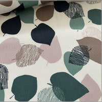 Fabric with abstract leaf pattern in various colors on a light background