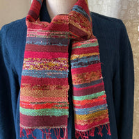 Colorful striped scarf on a mannequin with a plain background