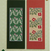 Two cross-stitch patterns on a textured background with decorative elements.