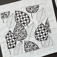 Open book displaying geometric and floral pattern illustrations.