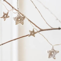 Tiny Crochet Star Garland Kit shown on branch | Brooklyn Haberdashery