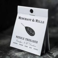 Merchant & Mills needle threader packaging on a dark background