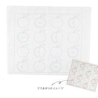 White cloth with apple shapes and a smaller version of the sashiko stitched cloth on a white background.