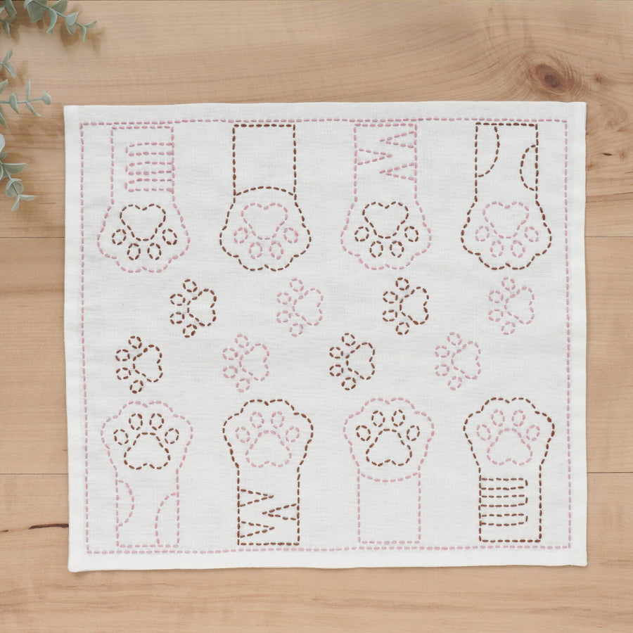 Embroidered fabric with paw prints