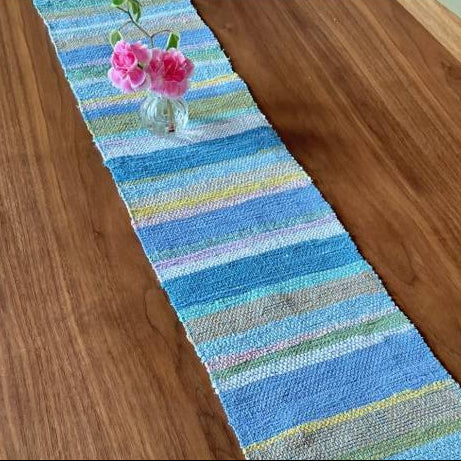 Colorful striped table runner on a wooden surface