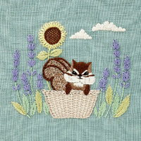 Embroidery design with a chipmunk in a basket surrounded by sunflowers and lavender on a textured background.