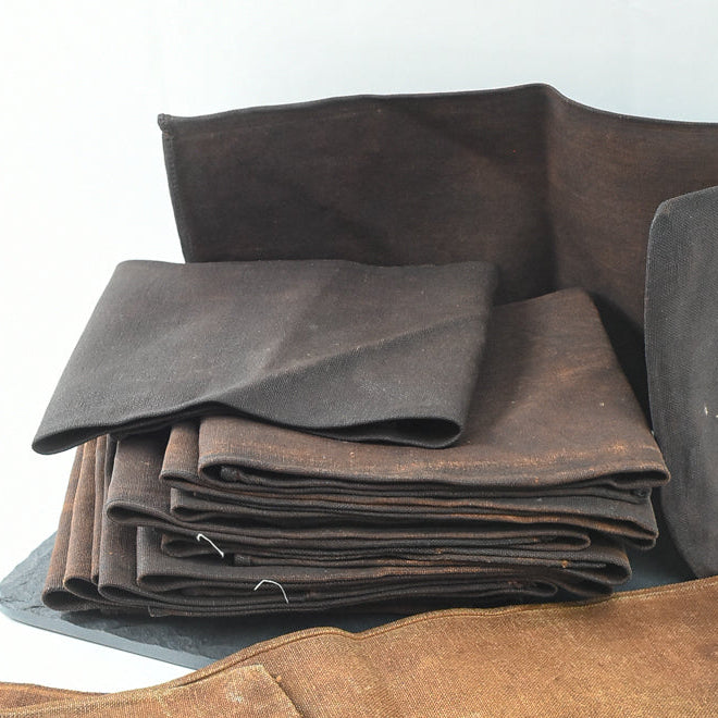 Stack of brown fabric pieces on a white background