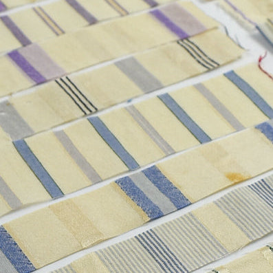 Collection of fabric swatches with various patterns and colors on a white background