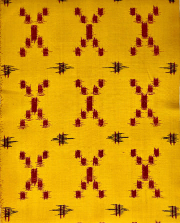 Textile with red and black pattern on a yellow background