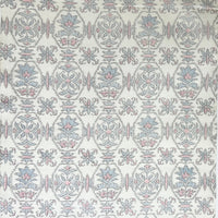 Patterned fabric swatch with geometric design on a white background