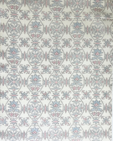 Patterned fabric swatch with geometric design on a white background