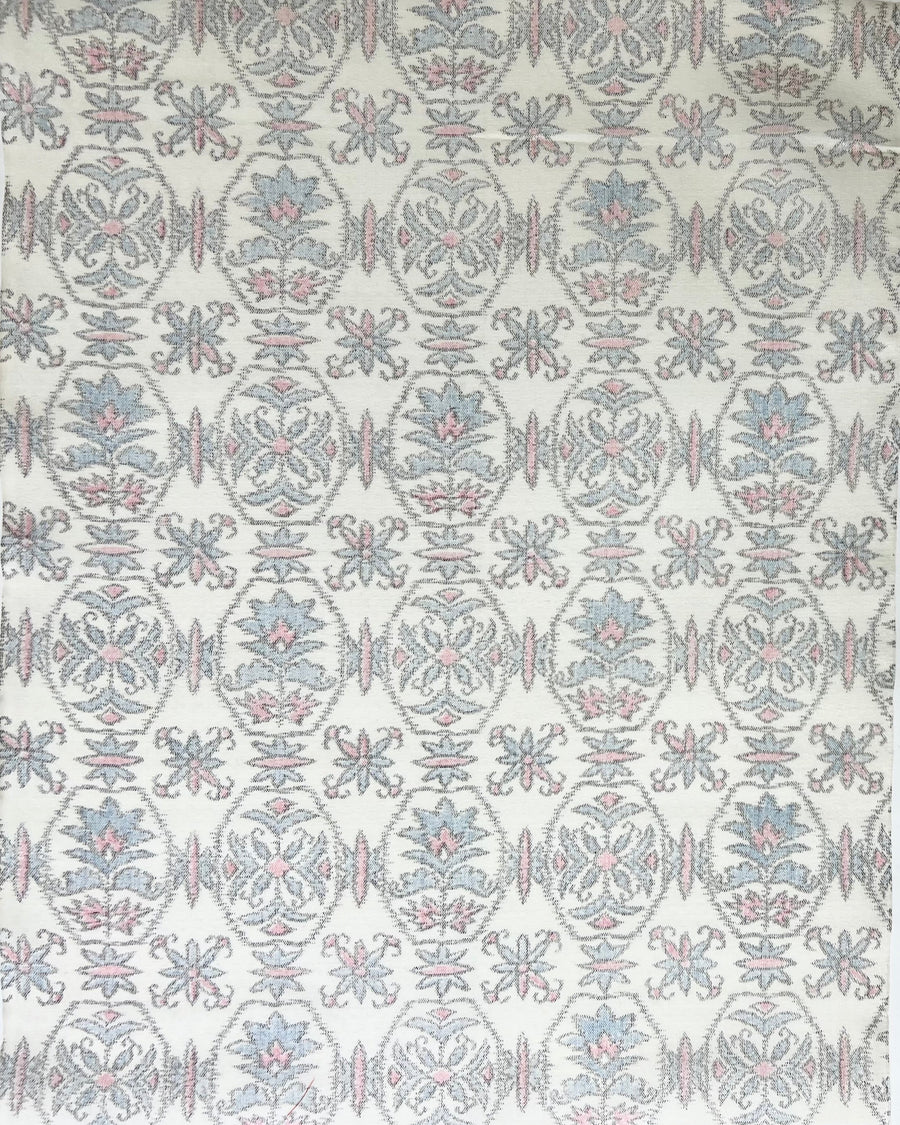 Patterned fabric swatch with geometric design on a white background