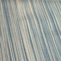 Striped fabric with blue and beige pattern on a roll