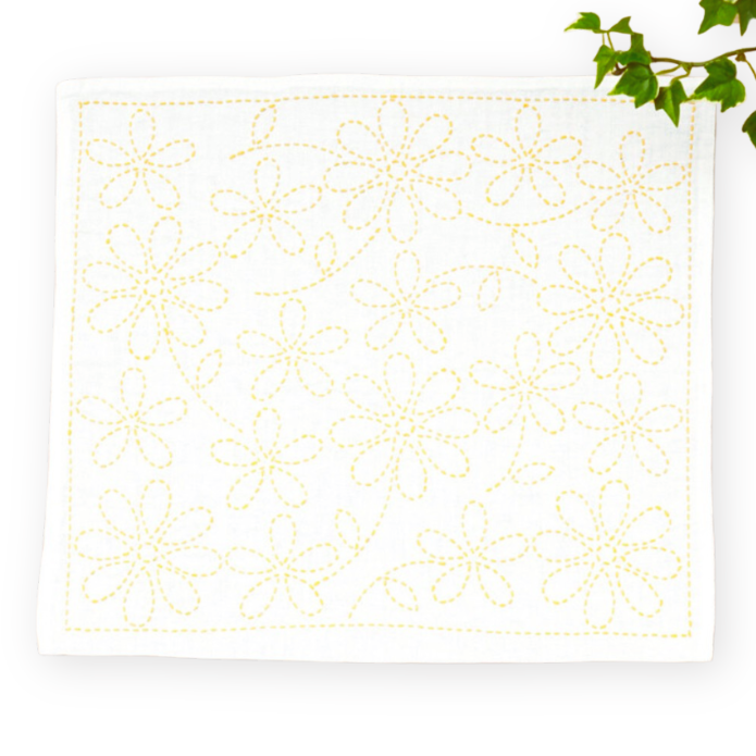 Decorative white placemat with gold floral pattern on a white background