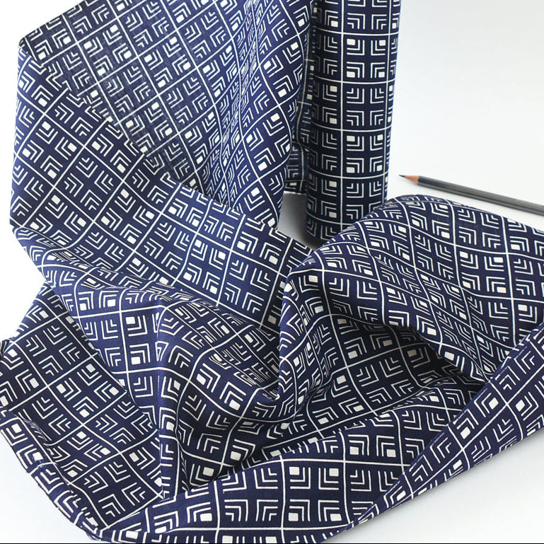 Blue fabric with geometric pattern on a white background