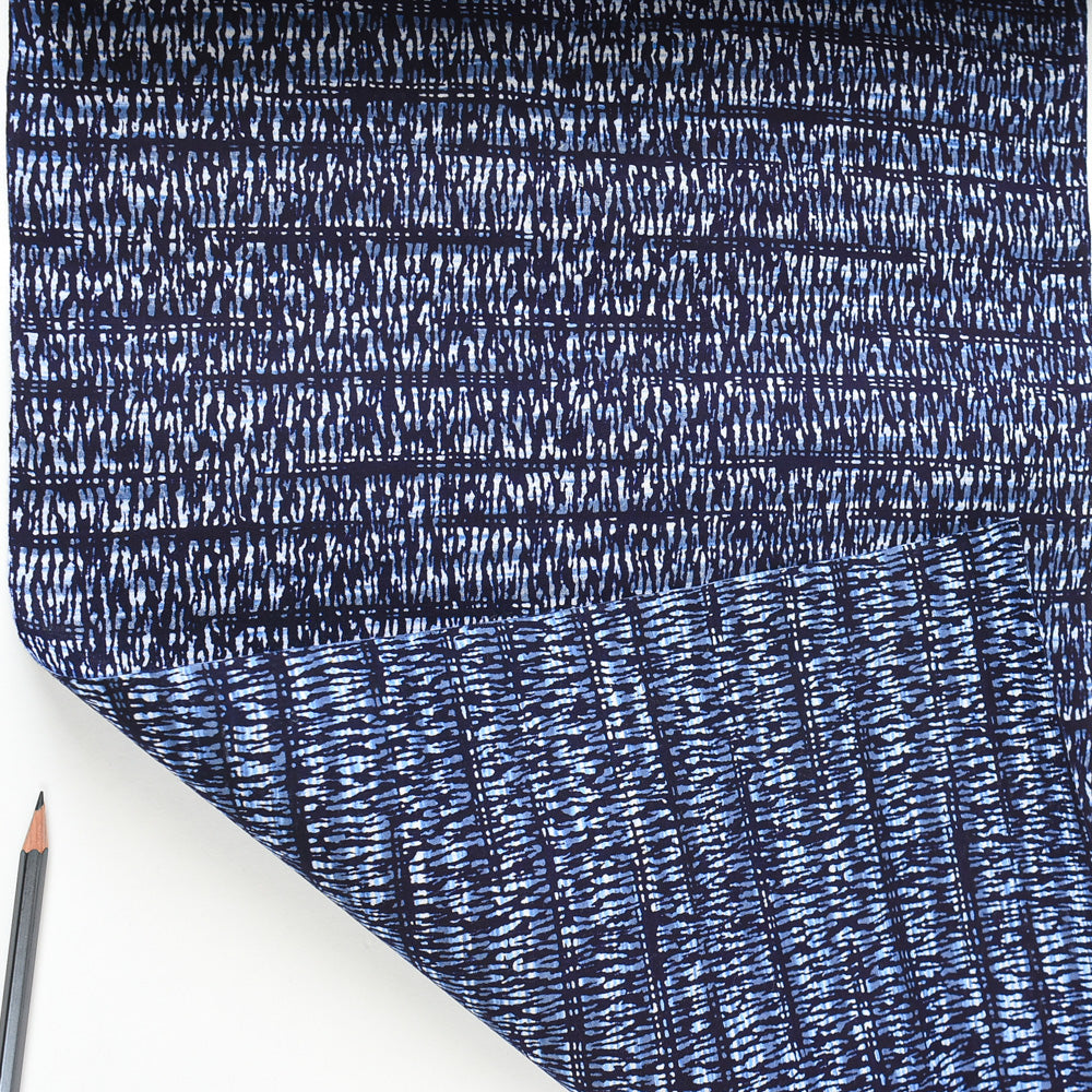 Close-up of blue textured fabric with a white background