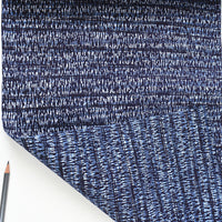 Close-up of blue textured fabric with a white background