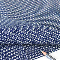 Blue checkered fabric with a pencil on a white background