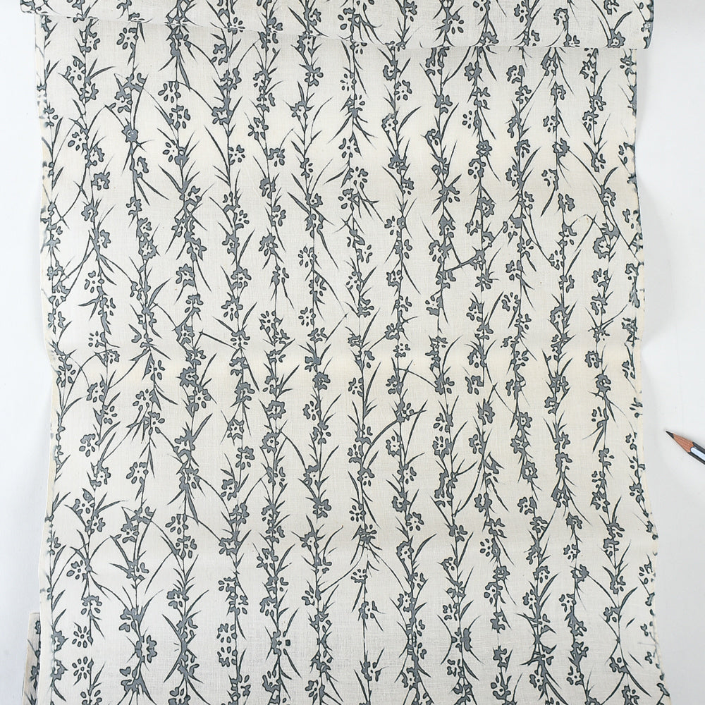 Floral patterned fabric with a pencil on a white background