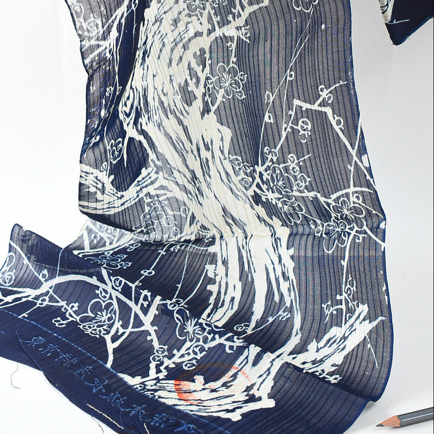 Blue fabric with white floral and wave pattern on a white background