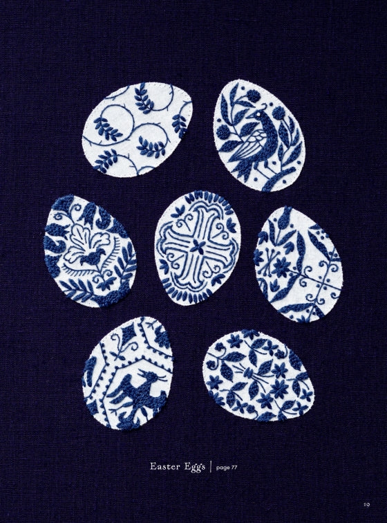 A dark navy blue fabric featuring seven white Easter eggs with various blue traditional floral and bird patterns, arranged in a circle. Small text at the bottom reads 'Easter Eggs | page 77'.