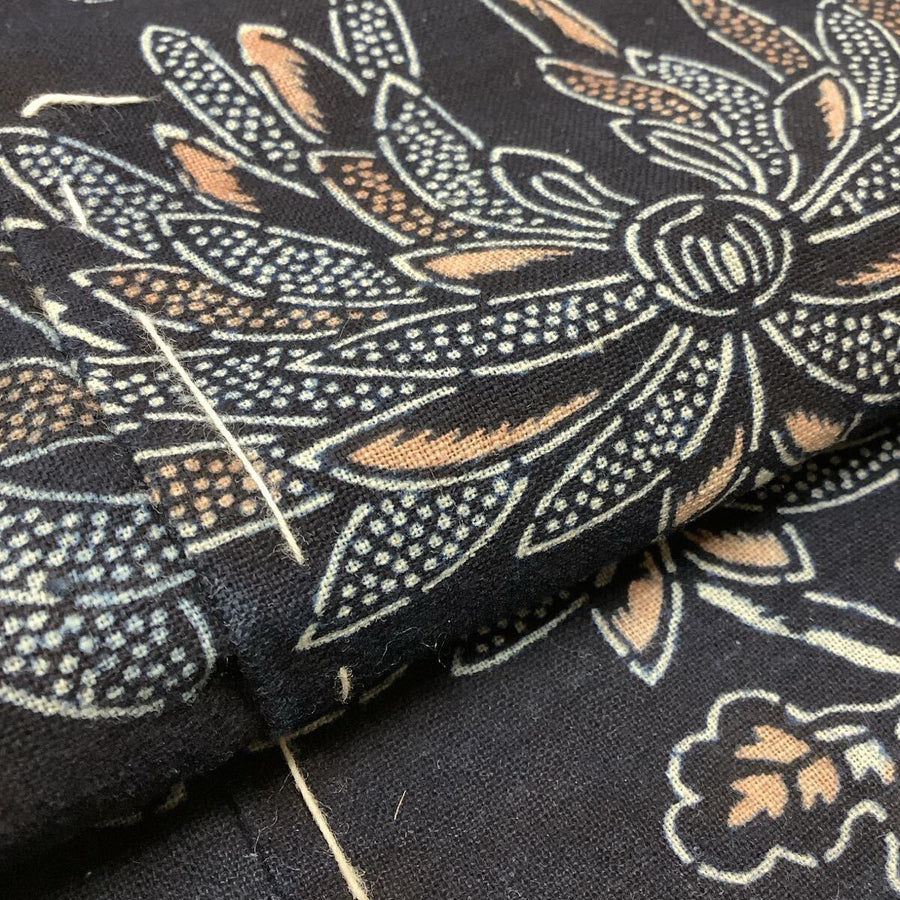 Close-up of patterned fabric with floral design on a dark background