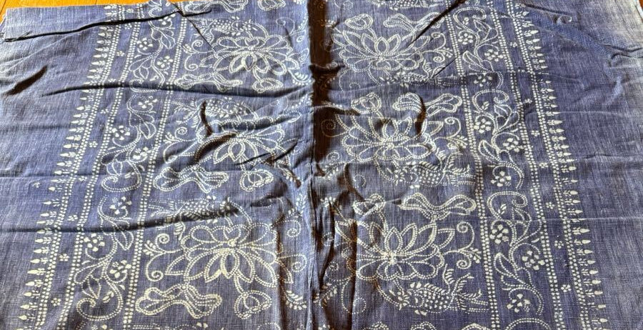 Blue fabric with white patterns on a wooden surface