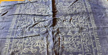 Blue fabric with white patterns on a wooden surface