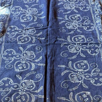 Blue fabric with white patterns on a wooden surface