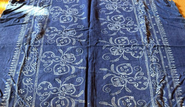 Blue fabric with white patterns on a wooden surface