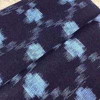 Navy fabric with blue geometric pattern on a neutral background