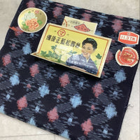 Vintage-style product packaging on a patterned fabric background