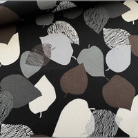 Patterned fabric with leaf shapes on a black background