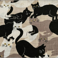 Pattern of black and white cats on a beige background