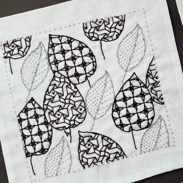 Open book displaying geometric and floral pattern illustrations.