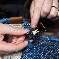 Cohana mini scissors with blue tassel, hands cutting, snipping thread