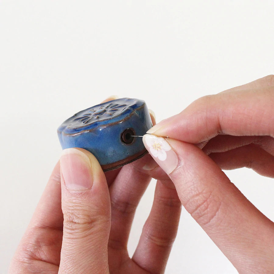 Awaji Kawara Magnetic Needle Minder shown with hands using needle polisher | Brooklyn Haberdashery