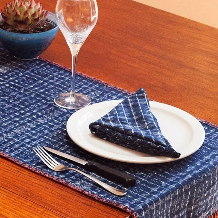 Toto cloth napkin in checkered indigo folded on dinner plate | Brooklyn Haberdashery