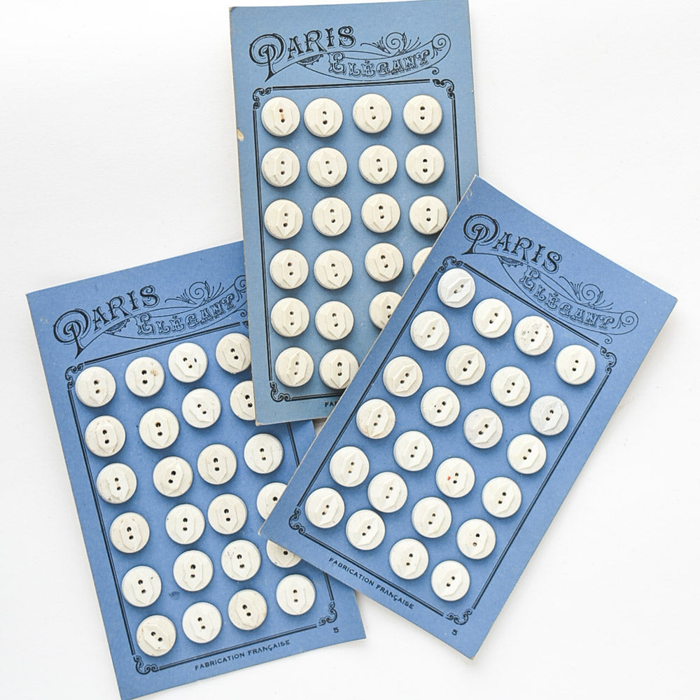 White Buttons "Paris Elegant" on Blue card, 1/2"